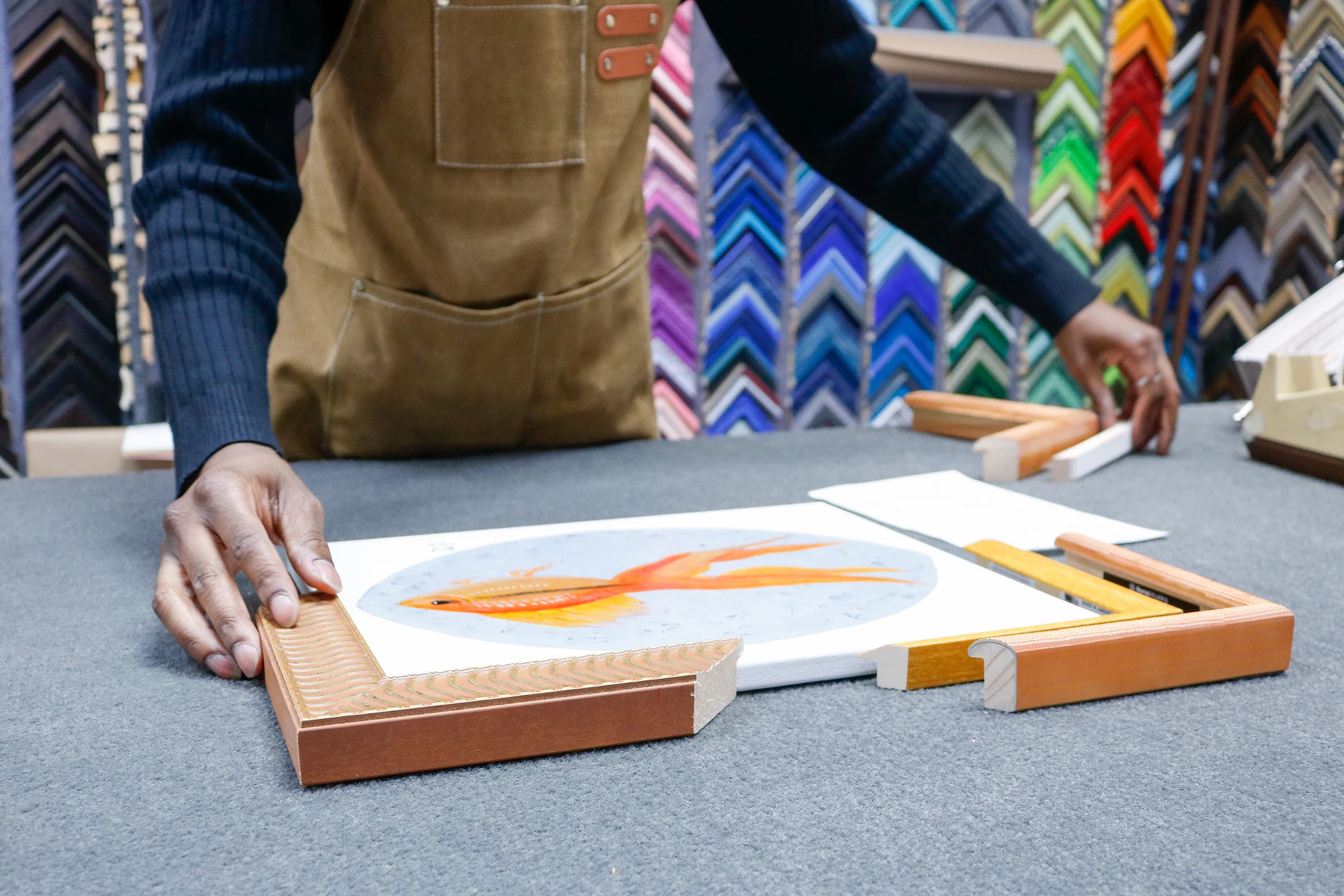 Hands at the workbench, fitting an oil into its mat